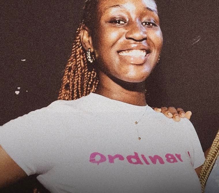 A guest in a white t-shirt smiling at the camera